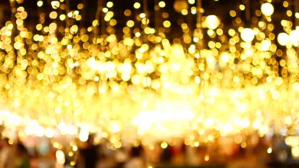 Gouden bokeh van kerstverlichting — Stockvideo