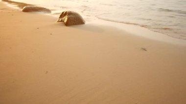 Mens legs for a walk along the shore, relaxation and tranquility
