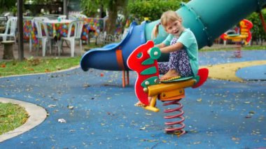 Child girl on the playground, day off