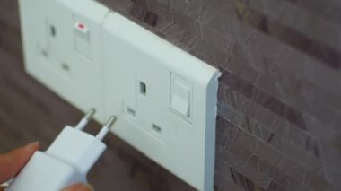Connecting the charger to a foreign outlet through an adapter