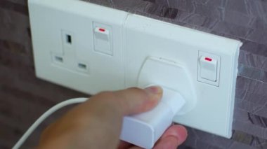 Connecting the charger to a foreign outlet through an adapter