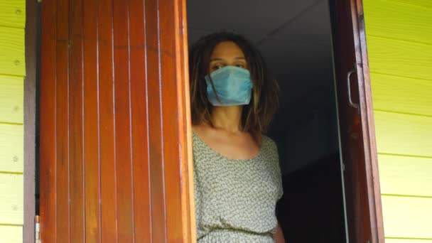 Masked European woman closes at home in quarantine. Coronavirus in Europe — Stock Video