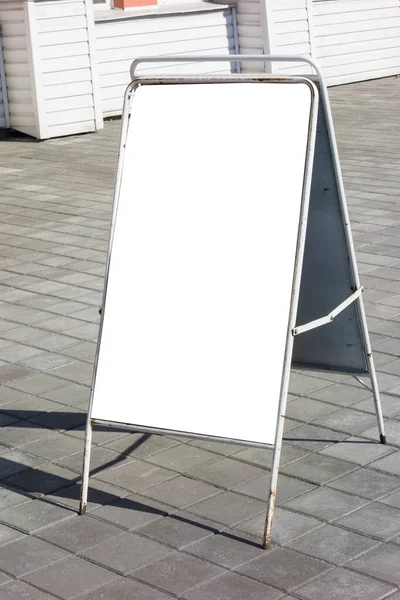 Blank advertising stand on the pavement