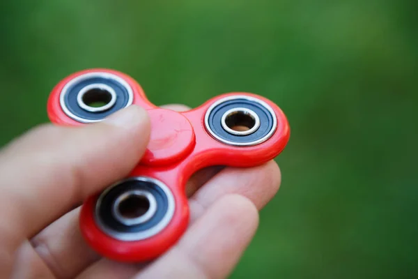 Red fidget spinner toy.Spinning device with bearings