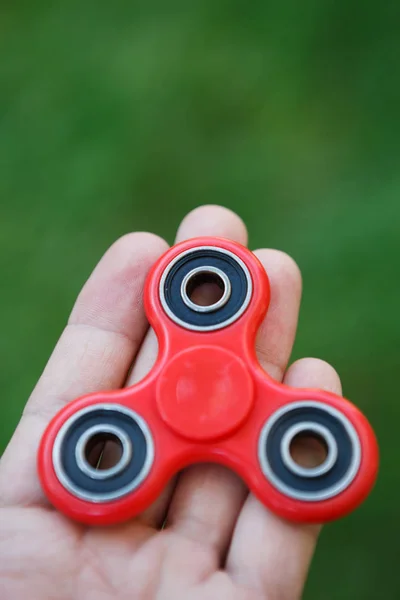 Red fidget spinner toy.Spinning device with bearings