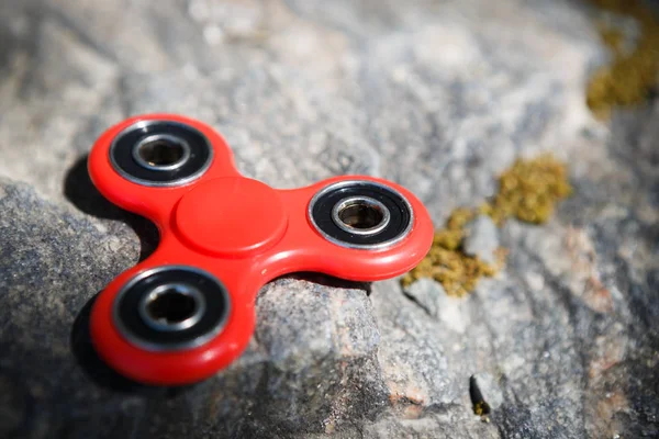 Red fidget spinner toy.Spinning device with bearings