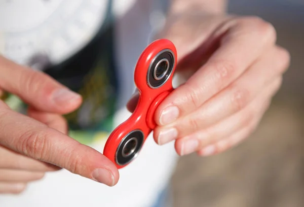 Red fidget spinner toy.Spinning device with bearings