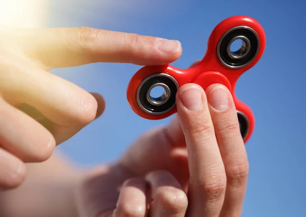 Red fidget spinner toy.Spinning device with bearings