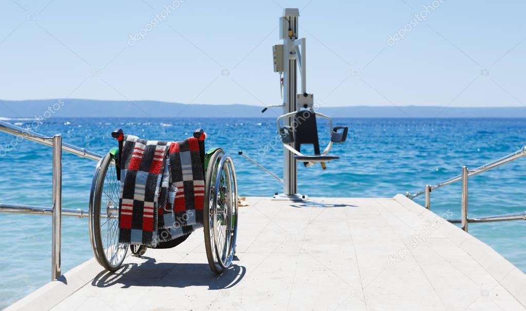 Wheelchair & lifting crane let handicapped people reach water