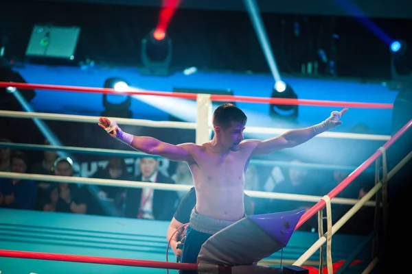 MOSCOW - 18 MARCH,2016: Big professional boxing event Fight For The Future at indoor sport arena.The winner boxer put hands up after the fight