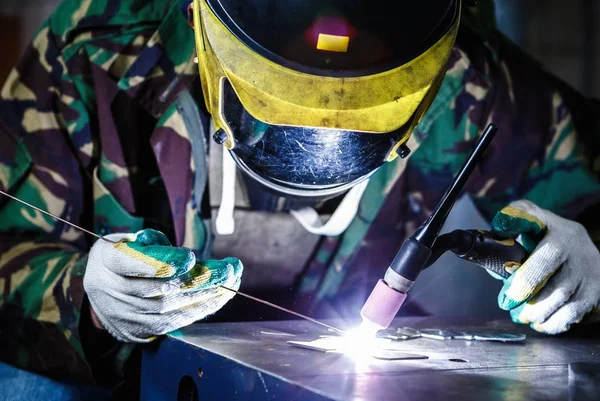 Welder welding with electric torch tool