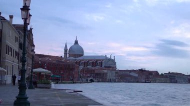 VENICE,ITALY-4 MAY,2019: Beautiful sunset in Guidecca,Venetian district near lagoon.Il Redentore christian church in Venezia.Popular travel destination for cultural tourism