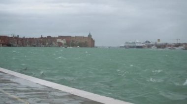 Venetian lagoon water in storm.Rainy day in Venice.Bad weather for cruise in Italian city Venezia.