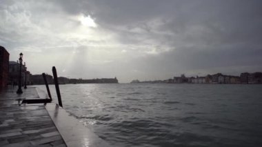 Beautiful Grand Canal in Venice after the storm.Dramatic cloudy sky in Venezia at dusk.Popular travel destination for cultural tourism in Europe.Venetian canals and old houses on background
