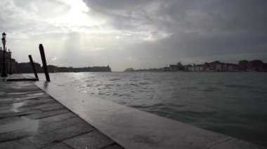 Beautiful Grand Canal in Venice after the storm.Dramatic cloudy sky in Venezia at dusk.Popular travel destination for cultural tourism in Europe.Venetian canals and old houses on background