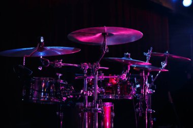 Drum set on rock concert stage.Professional musical instruments for drummer musician.Classic analog audio equipment for metal band live performance.Drumming instrument on rock festival clipart