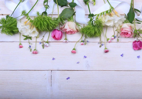 Composición floral festiva sobre fondo de madera blanca. Vista aérea. — Foto de Stock