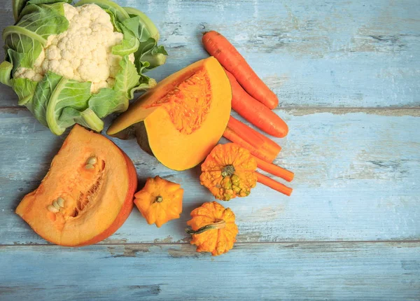 Moscatel de calabaza, simple y decorativo, zanahorias y coliflor sobre un fondo rústico de madera azul. Alimentación saludable, concepto vegetariano . — Foto de Stock