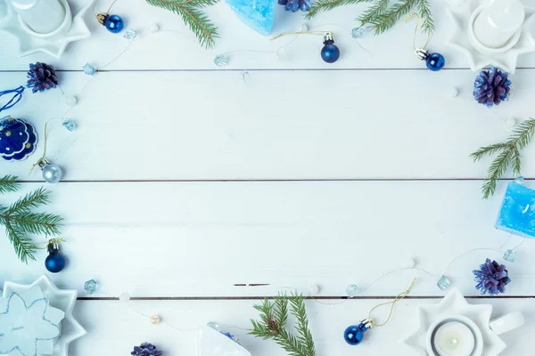 Christmas composition. Pine cones, spruce branches, handmade candles, Christmas blue decor on a wooden white background. — Stock Photo, Image