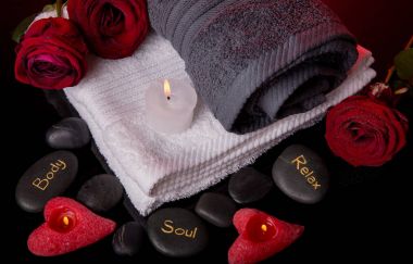 Spa concept in Valentine's Day, red roses, candles in the shape of heart, spa stones with the inscription soul, body, relax clipart