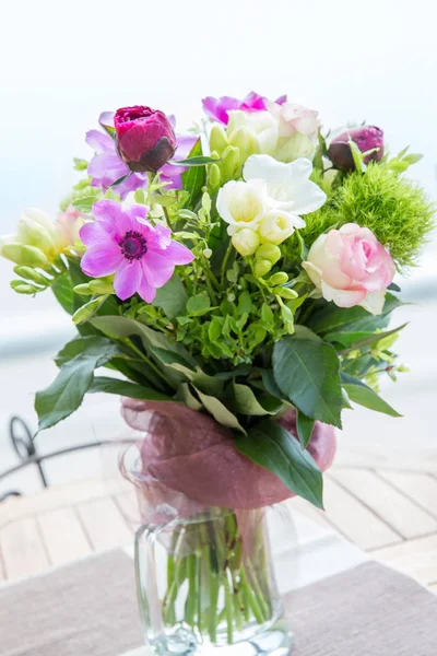 Large beautiful bouquet of peonies, roses, anemones in a vase