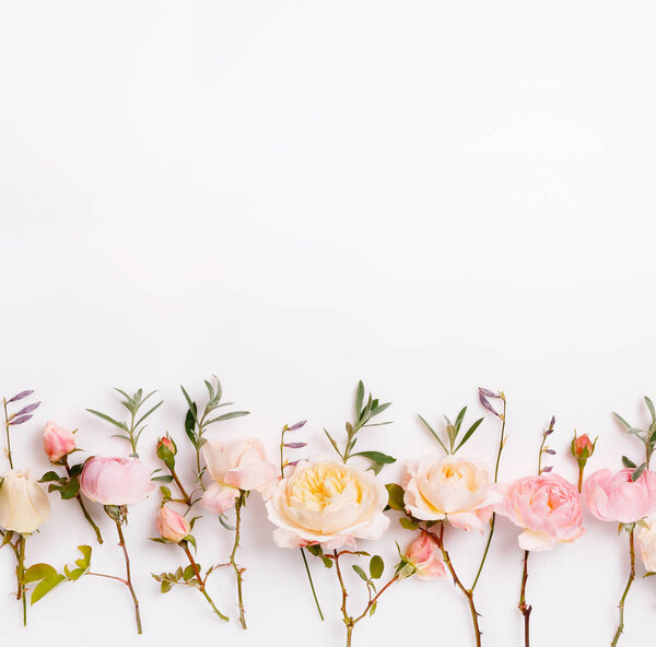 Festive flower composition on the white wooden background. Overhead view