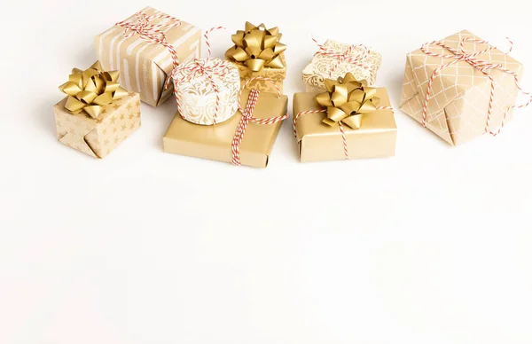 Gift or present boxes and stars confetti on white table top view. Flat lay composition for birthday, christmas or wedding.