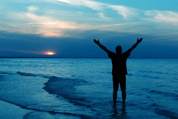 Silhouette of Man Raising His Hands or Open arms when sun rise Стоковое Фото