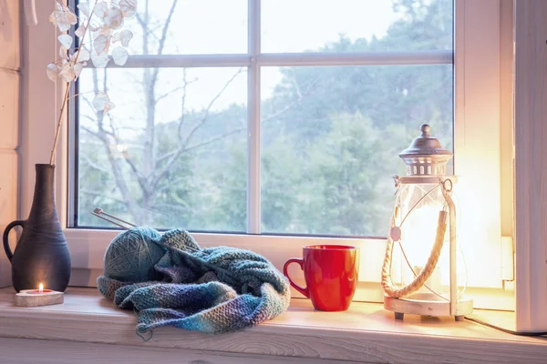 Festive lantern, red mug and heart on a wooden window sill in winter indoors. — Stock Photo, Image