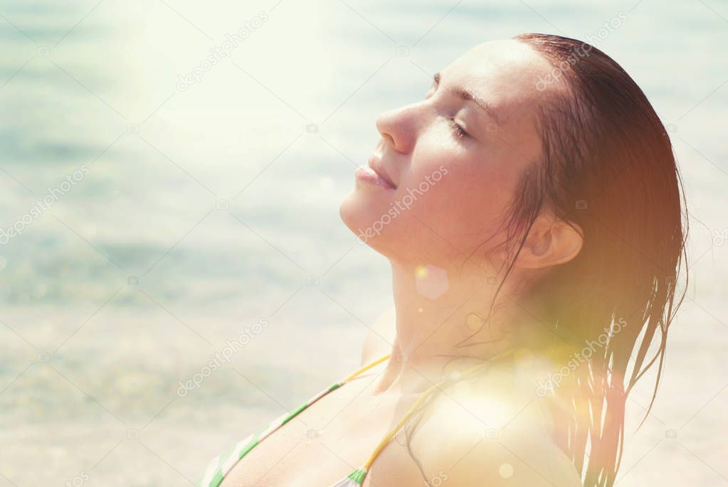 Beautiful Woman  on the Sea Beach at Summer. Sun Beams. 