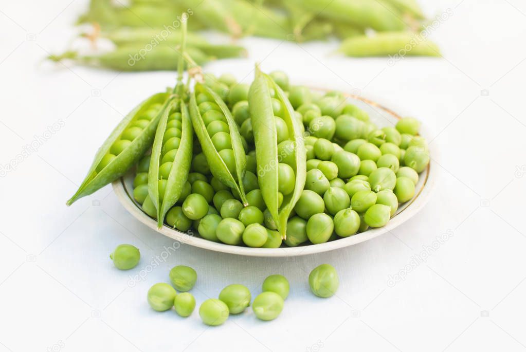 Green pea in a bowl of top view on white background with copy space