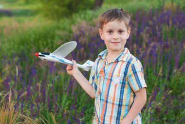 Happy kid playing with toy plane