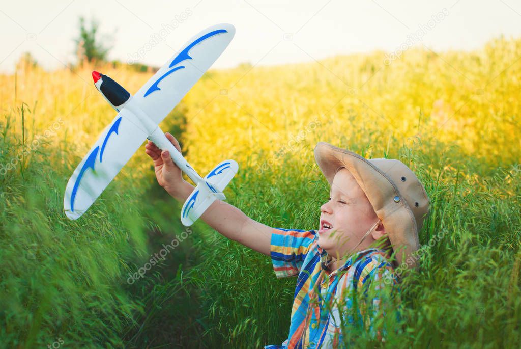 Happy kid playing with toy plane