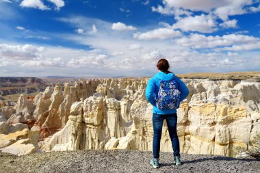 Hiker admiring views of sandstone formations clipart