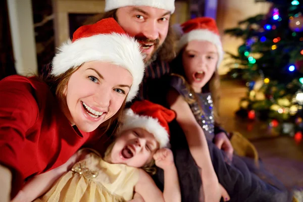 Happy family taking selfie on Christmas — Stock fotografie