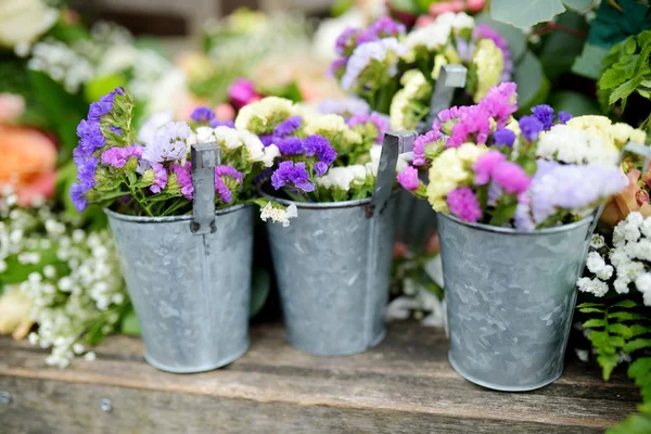 Three buckets of beautiful purple and white flowers — Stock Photo, Image