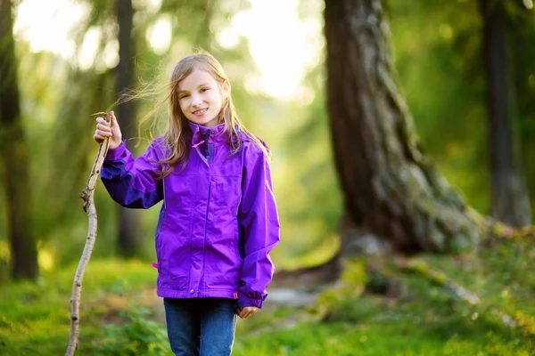 Милая маленькая девочка развлекается во время лесного похода в прекрасный осенний день — стоковое фото