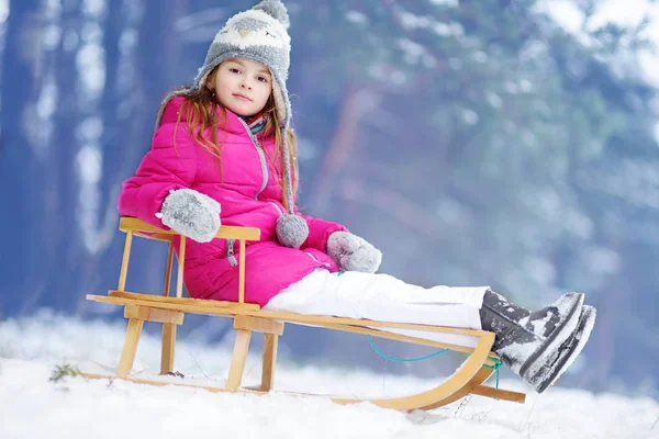 Funny little girl having fun with a sleight — Stock Photo, Image