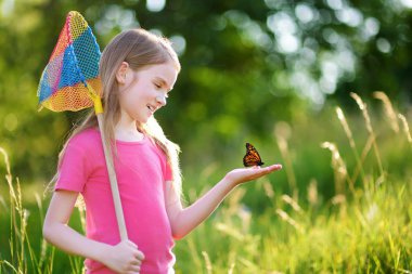 Little girl catching butterflies  clipart