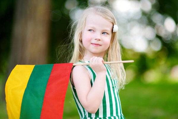 girl holding Lithuanian flag