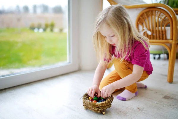 Girl playing with colored Easter eggs — Stock Photo, Image