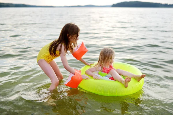 Little sisters having fun swimming — Stock Photo, Image
