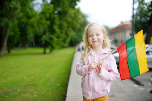 Girl holding tricolor Lithuanian flag — Stock Photo, Image