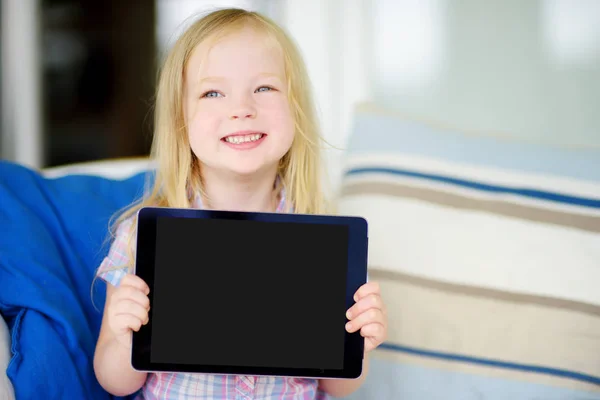 Smart little schoolgirl with digital tablet — Stock Photo, Image