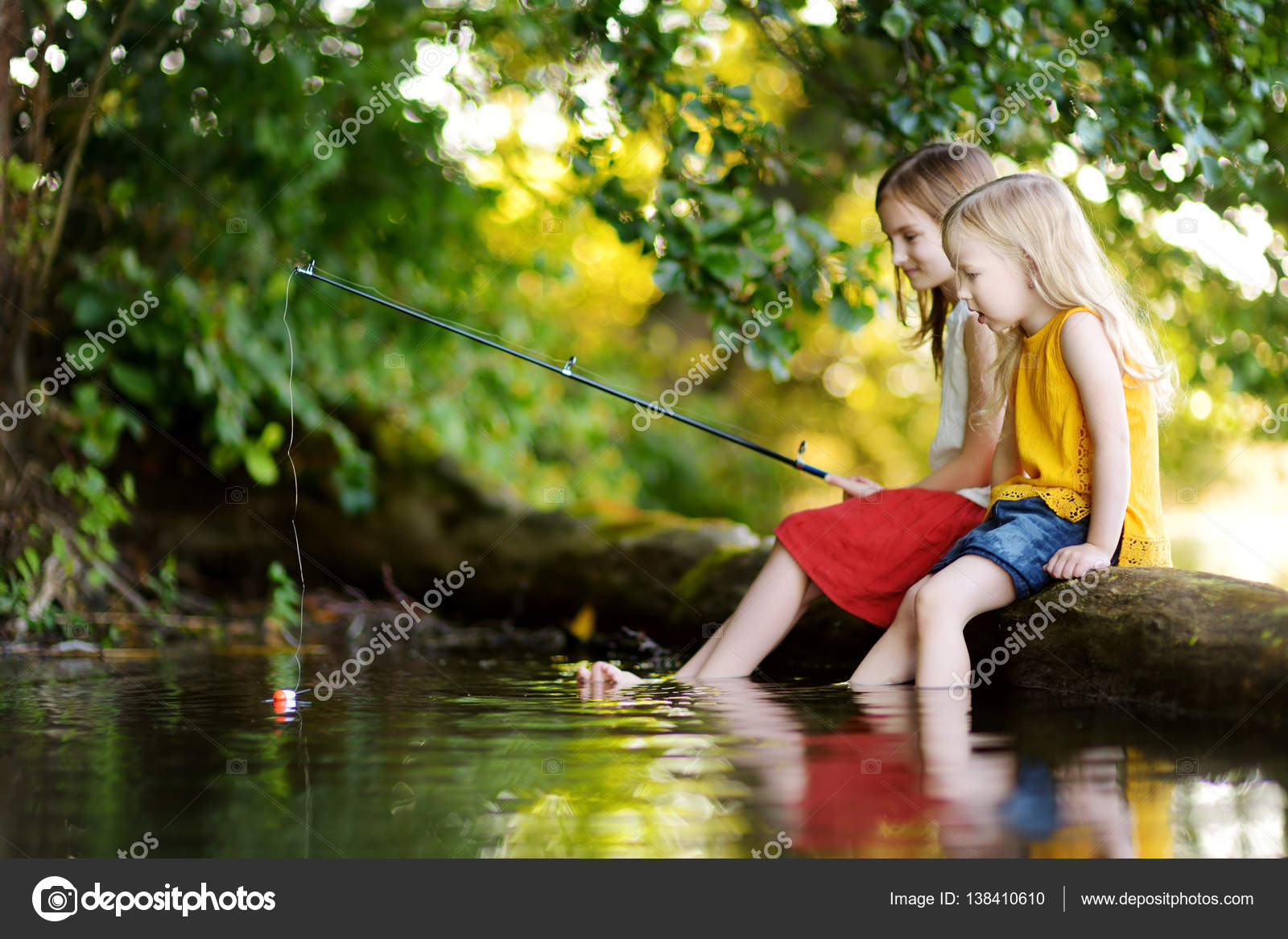 Little girls having fun by a river — Stock Photo © MNStudio #138410610