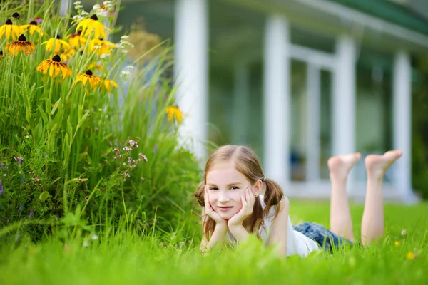 Cute little girl having fun on a grass — Stock Photo, Image