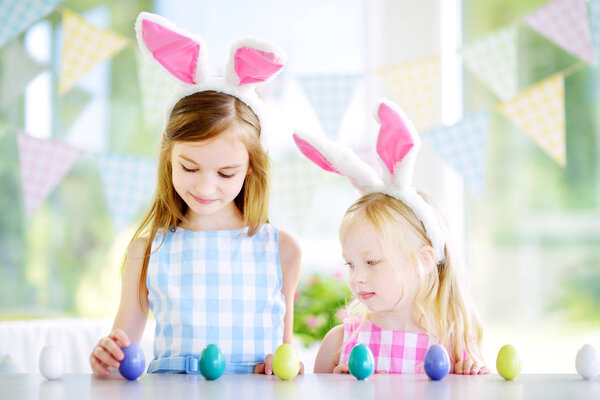sisters  playing egg hunt on Easter