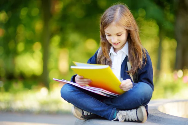 Little schoolgirl with books — Stock Photo, Image