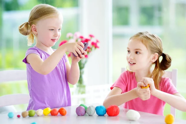 Sisters with modeling clay — Stock Photo, Image