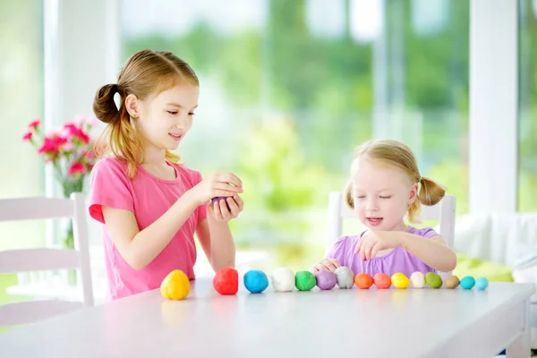 Sisters with modeling clay — Stock Photo, Image